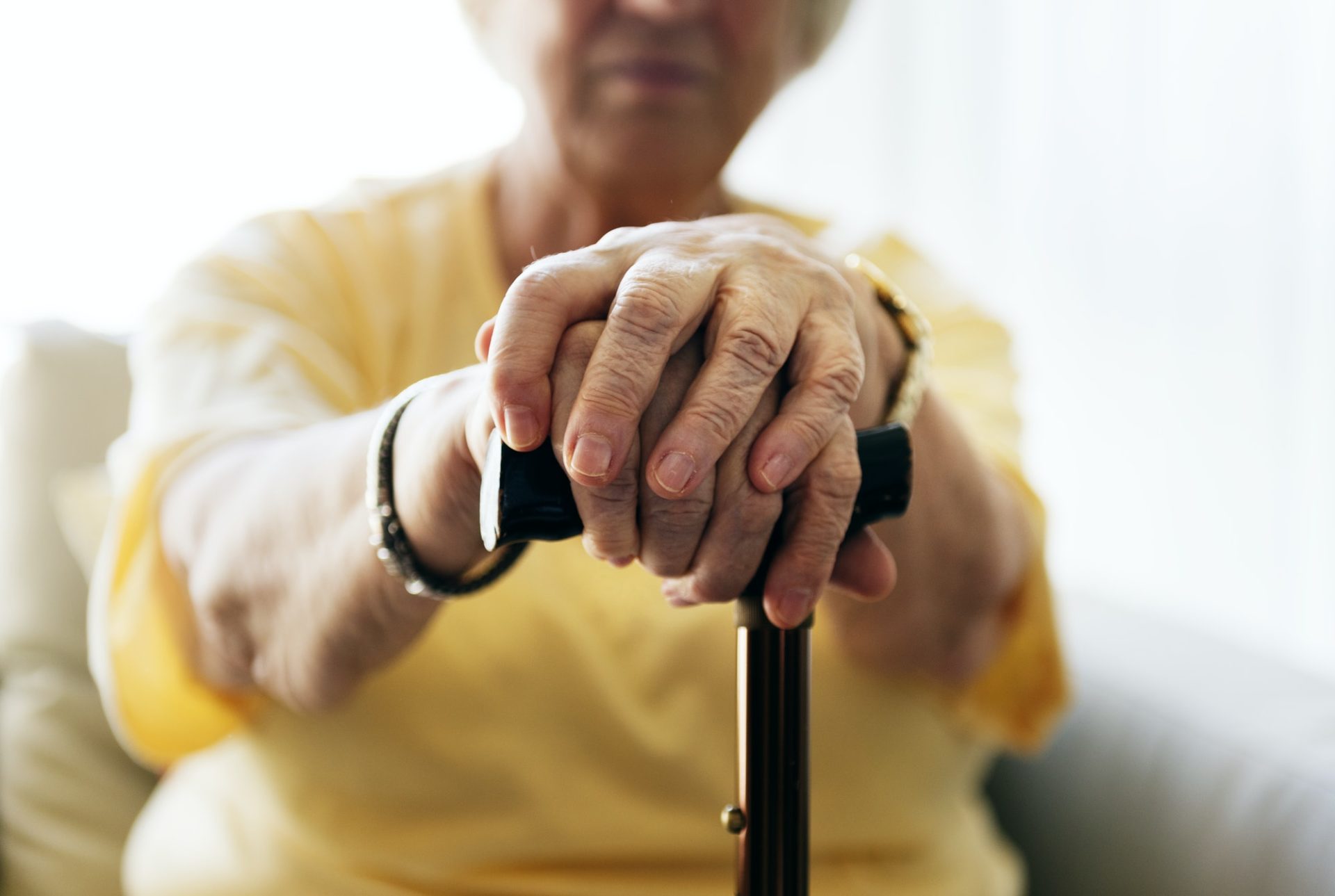 Senior woman holding a walking stick